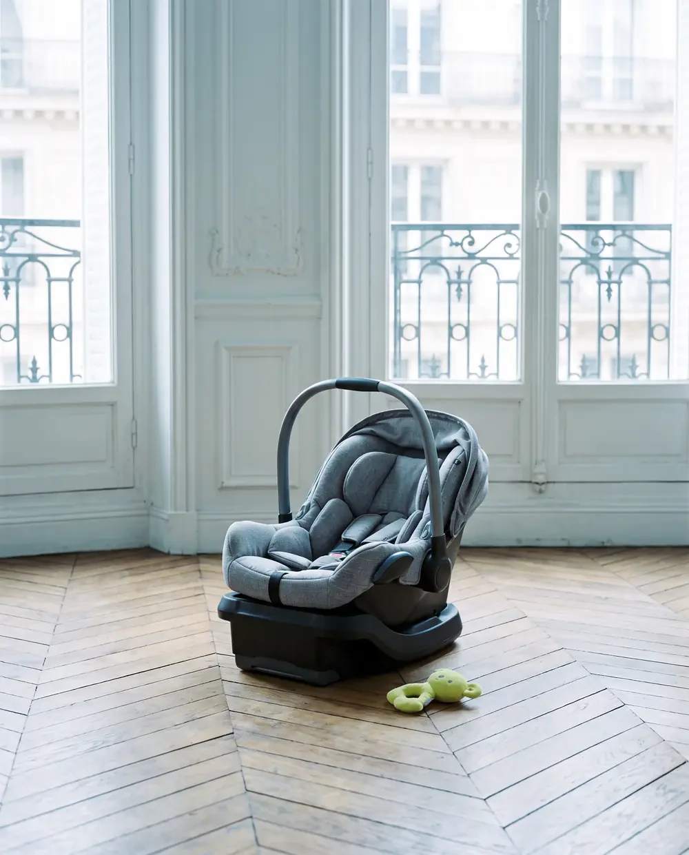 An infant car seat in a generated Paris apartment scene